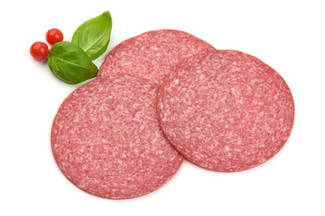 Salami sausage slices with basil leaves, top view, isolated on white background