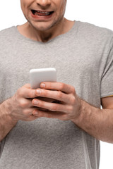 cropped view of man using smartphone and grimacing isolated on white