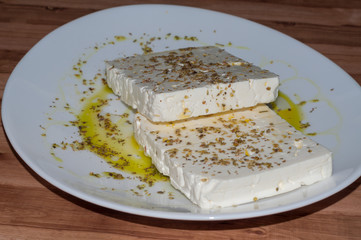 Large pieces of feta cheese in white plate