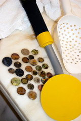 The photo of gold and silver  coins collected with help of underwater metal detector. Treasure searching and tourist adventure background.