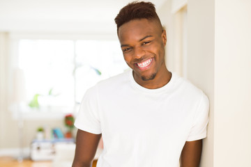 Fototapeta premium Handsome african young man smiling cheerful with a big smile on face