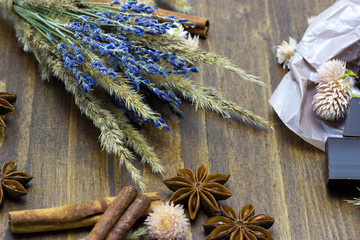 natural chocolate with lavender flowers cinnamon and star anise on a wooden background