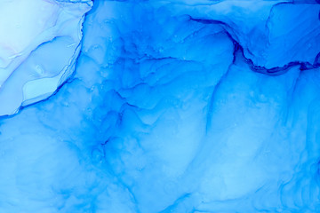 Fluid ink hand painted abstract background. Blue and ultramarine colors.