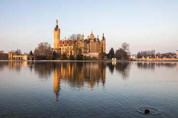 Dawn at Schwerin Palace (Schweriner Schloss), reflected in the water of Schweriner See lake. World Heritage Site in Mecklenburg-Vorpommern, Germany