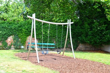 Playground with playground equipment like swing slide and seesaw