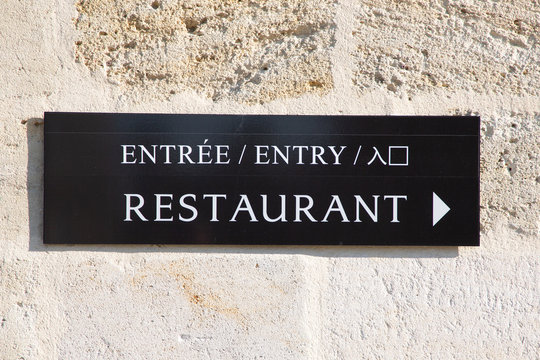 arrow sign restaurant entry in multilingual