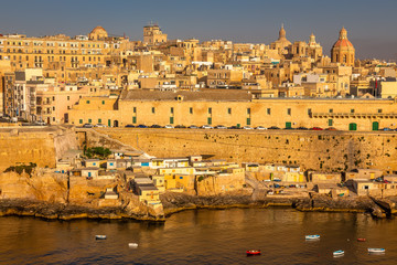 Fototapeta premium Valletta from the Ship. Exposure of Valletta, Malta, taken at Sunrise from a ship while arriving at this beautiful fortified city.