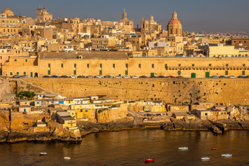 Fototapeta premium Valletta from the Ship. Exposure of Valletta, Malta, taken at Sunrise from a ship while arriving at this beautiful fortified city.