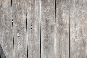 Background of three wooden boards with knots. Brushed boards with nails and knots of natural color. Textured wooden wall.