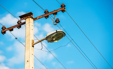 Electric pole with a lamp and lot of wires