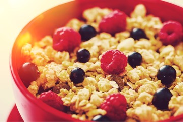 Raw oats in bowl and fruit salad, apples on the wooden table