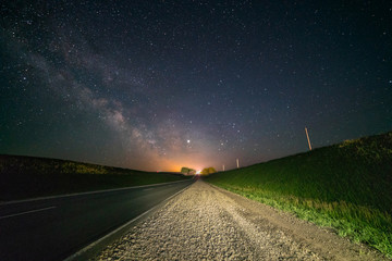 Road, under the night starry sky. Milky Way, over the highway