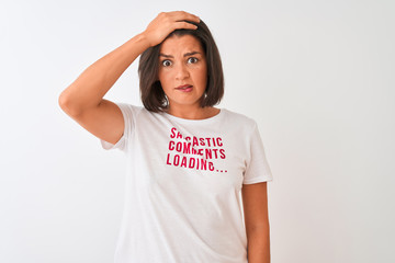 Young beautiful woman wearing fanny t-shirt standing over isolated white background stressed with hand on head, shocked with shame and surprise face, angry and frustrated. Fear and upset for mistake.