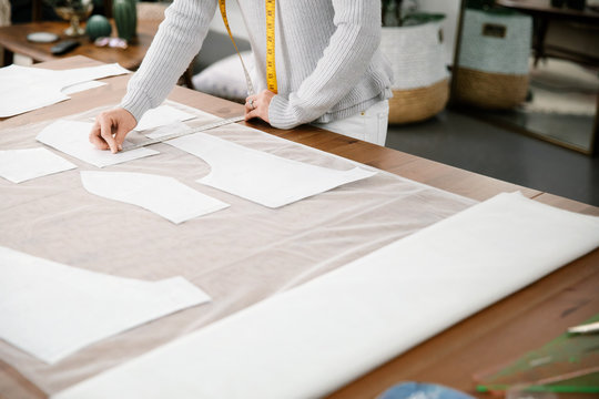 Close up of designer measuring pattern on fabric