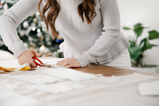 Close up of designer cutting out fabric pieces with pattern