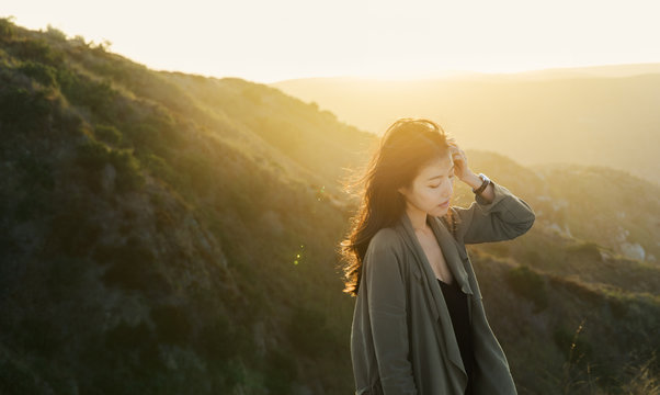 Young woman pushes hair behind ear
