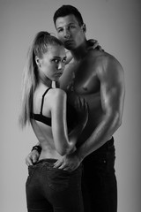 Black and white fashion shoot of young couple with nice body.