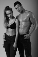 Fototapeta na wymiar Black and white fashion shoot of young couple with nice body.