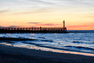 Romantic colorful sunset at Courseulles-sur-Mer pontoon. French Normandy
