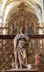 Statue of praying woman inside gothic european cathedral