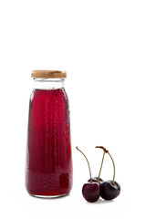 one bottle of cherry juice and ripe cherry on white background
