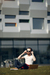 Handsome guy in a white t-shirt. Businessman working in a city