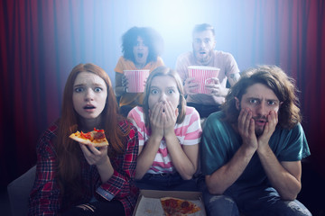 Group of friends watch a film at the cinema