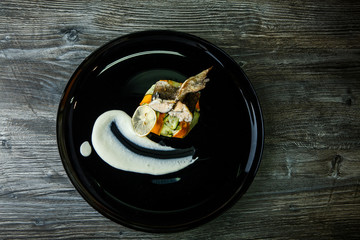 top view on delicious stuffed sea fish on vegetables garnish