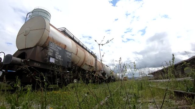 Wagons for liquids waits for further transportation on train depot low angle