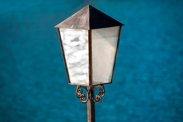 white street lamp , blue water background