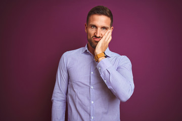 Young business man wearing elegant shirt over purple isolated background thinking looking tired and bored with depression problems with crossed arms.