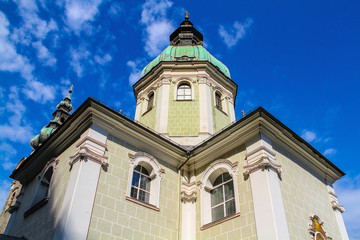 Fototapeta na wymiar One of the churches of the city of Salzburg (Austria) against a cloudy sky