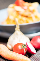 Pasta, spaghetti with cheese, mushrooms and tomato. Healthy food. Focus on vegetables.