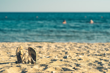 Fototapeta na wymiar summer background with flip flops on a sandy beach