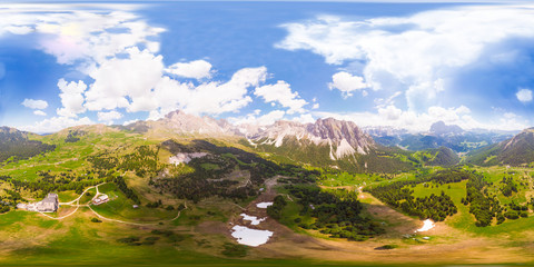 Amazing aerial 360 degrees view on Seceda Mount peak and valley from drone in summer sunny day. Dolomites Alps, South Tyrol, Italy, Europe near Ortisei. Odle mountain range and Puez massif Val Gardena