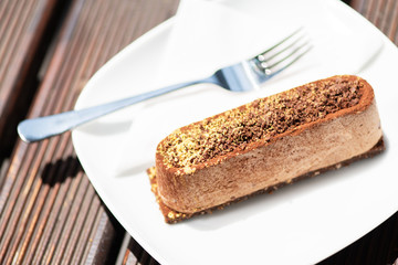 Tasty chocolate cake on the wooden table.