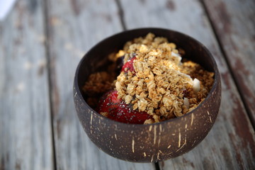 acai bowl beach bar ice-cream muesli strawberry dessert wood table vintage coconut bowl Rustic Coconut Bowl with Homemade Granola and Berries