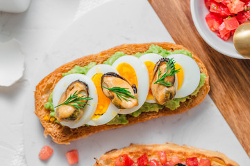 Tapas with mussels and avocado on crusty bread