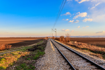 Railway line between the agricultural fields in March, Serbia