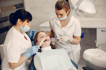 Obraz premium Beautiful lady in the dentist's office. Woman in a uniform
