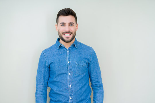 Young handsome man over isolated background with a happy and cool smile on face. Lucky person.