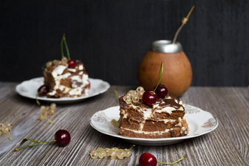 two pieces of chocolate cake with a cherry