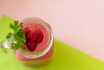 smoothies with raspberries on a colored background. selective focus. 