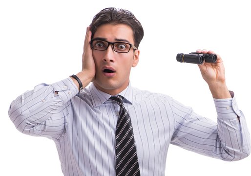 Young handsome businessman looking into future with binoculars