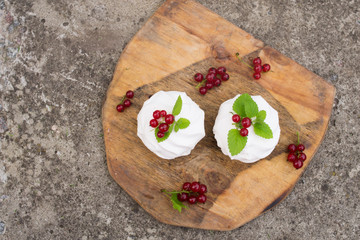 Homemade pink marshmallow and pavlova cake with strawberry, blackberry, currant, cherry and mint leaf. top view.