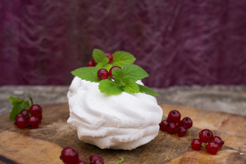 Homemade pink marshmallow and pavlova cake with strawberry, blackberry, currant, cherry and mint leaf.