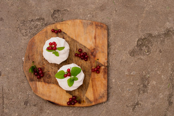 Homemade pink marshmallow and pavlova cake with strawberry, blackberry, currant, cherry and mint leaf. top view.