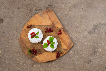 Homemade pink marshmallow and pavlova cake with strawberry, blackberry, currant, cherry and mint leaf. top view.