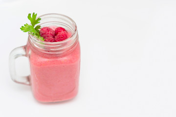 smoothies with raspberries on white background