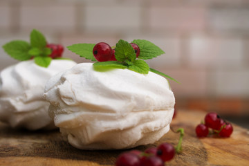 Homemade pink marshmallow and pavlova cake with strawberry, blackberry, currant, cherry and mint leaf.